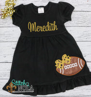 Personalized Black and Gold Glitter Football with Bow on Colored Garment
